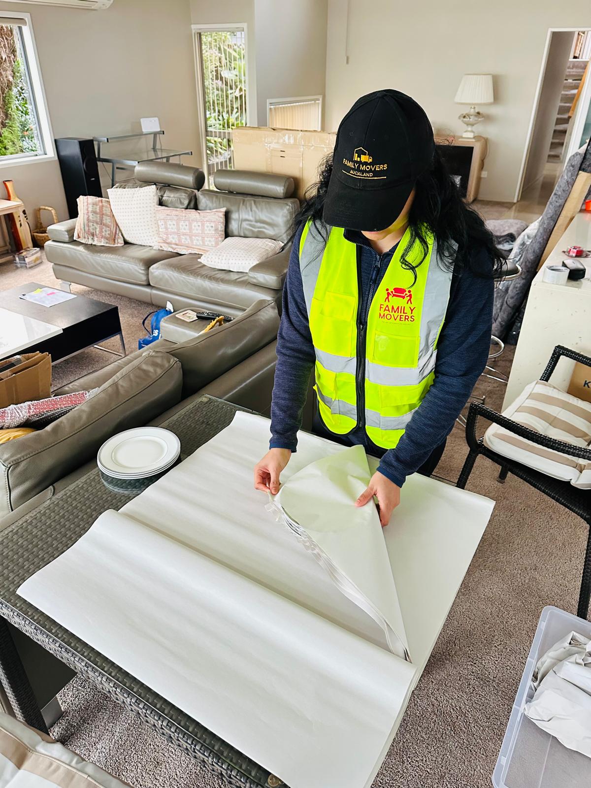 Family Movers crew member carefully wrapping furniture during a retirement move